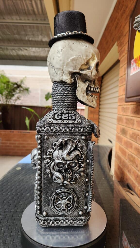 Braids, beads and chains used on skull bottle art