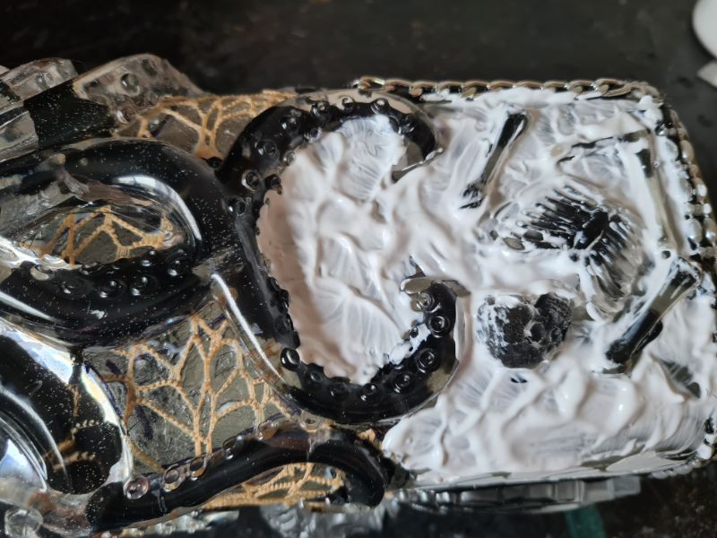 glue applied around skeleton to hold the stones