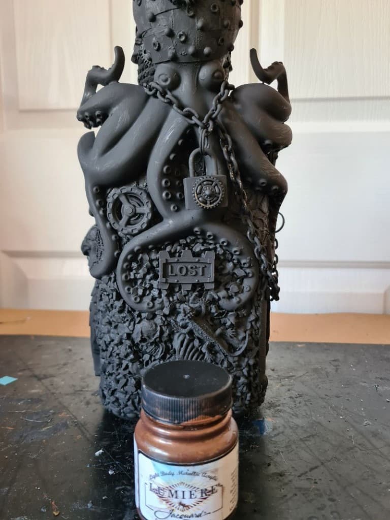 “Bottle coated in black gesso to unify all textures and parts.