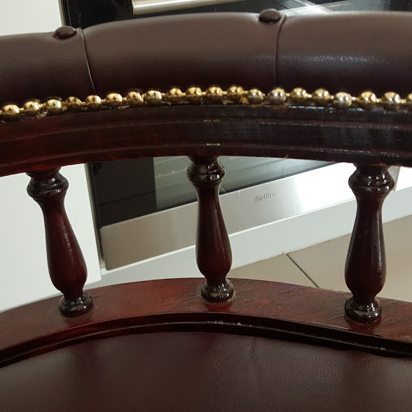 Restored wood on chair with gold studs