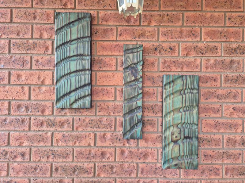 Abalone-effect Shou Sugi Ban wall art panels on display