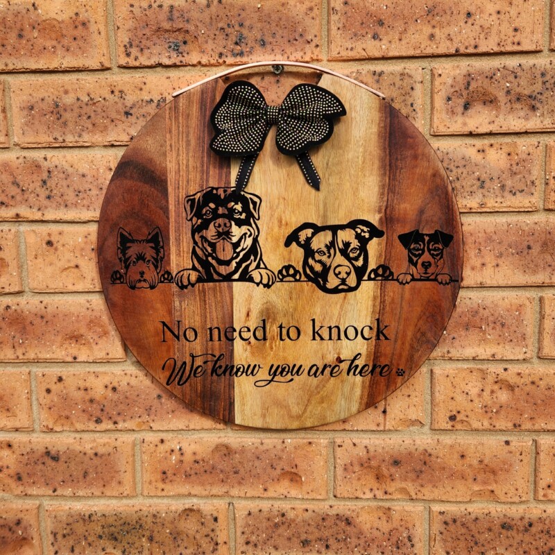Welcome sign with dog decals on a wooden cheeseboard