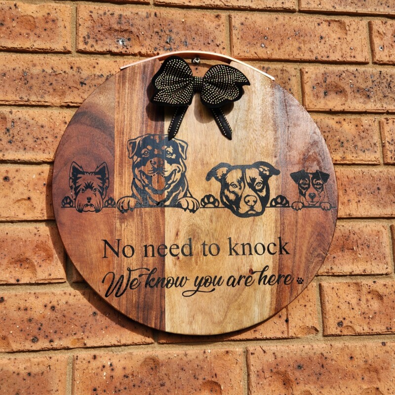 wooden porch sign with dog images and quote. 