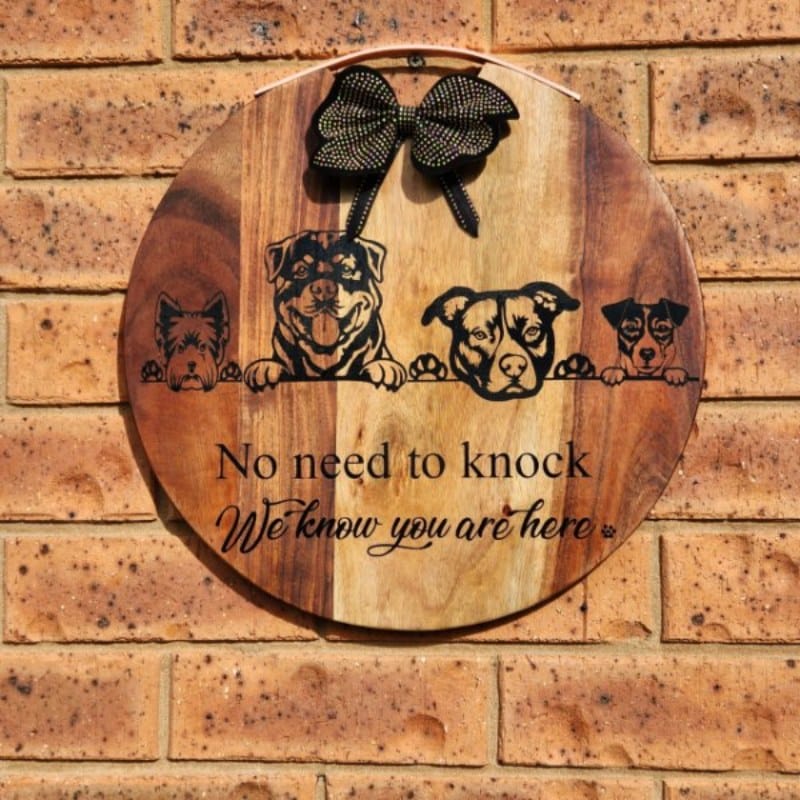 Wooden cheeseboard porch sign with dog decals.