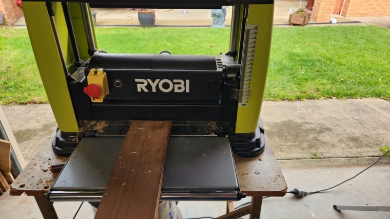 Planing reclaimed timber boards to clean bare wood