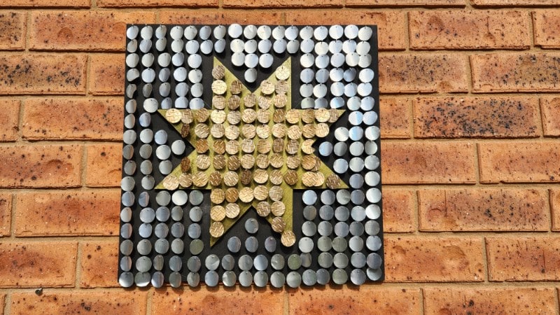 Soda can circles nailed to wood - shimmer can art