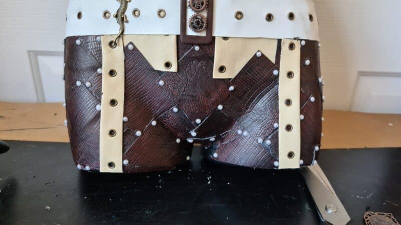 bottom of mannequin with beads on corner of patches