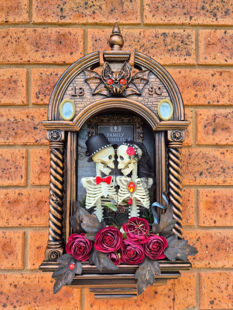 Gothic skeleton couple inside the completed mausoleum