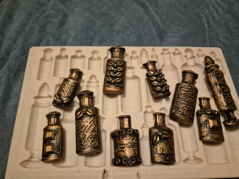 Resin urns made from hot glue painted black