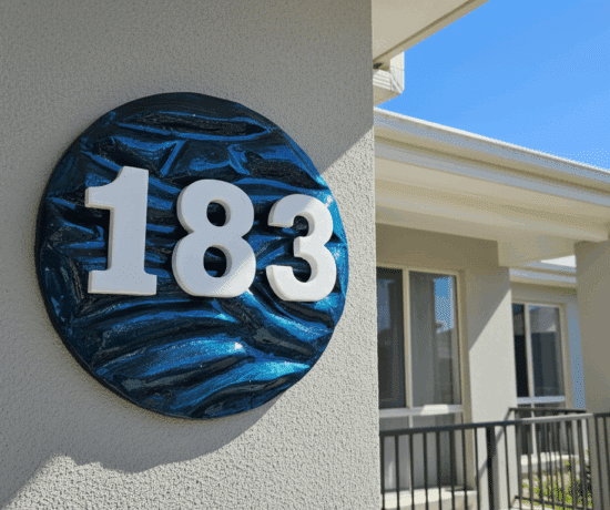 wooden textured house number on brick wall