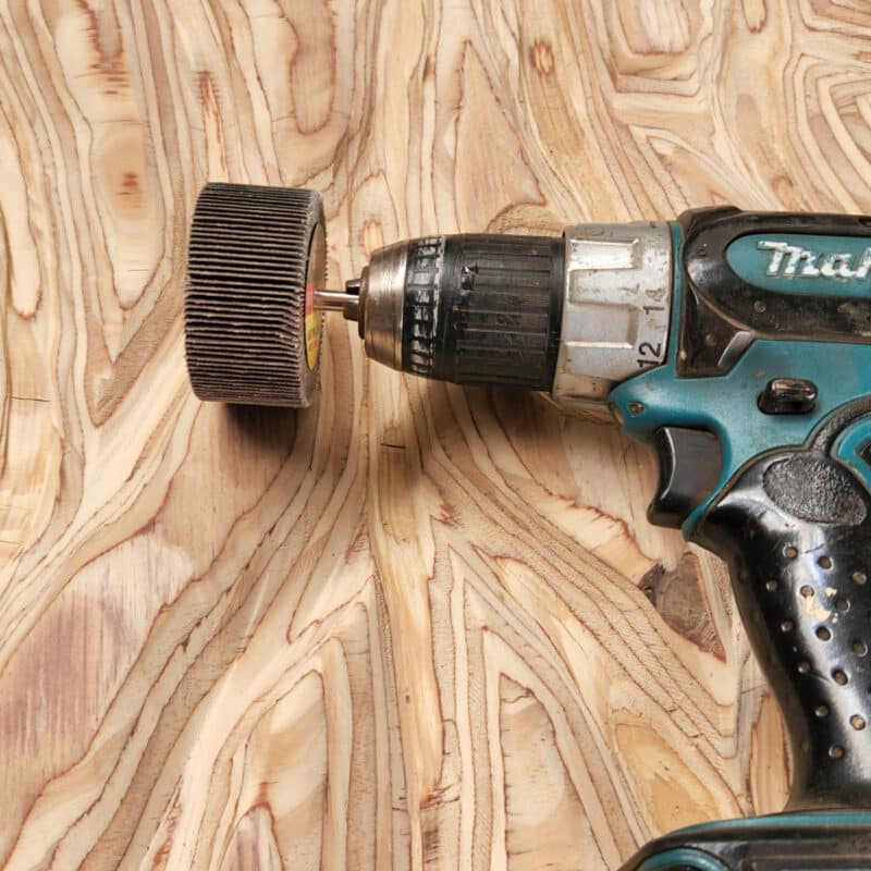 flap disc attached to a drill for smoothing wood