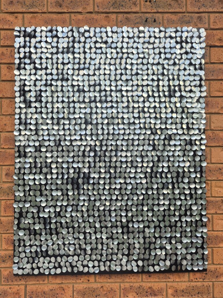 completed moving mosaic hanging on the wall