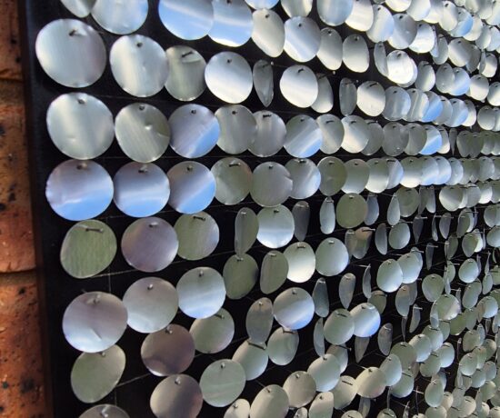 side view of aluminium circles nailed to the board