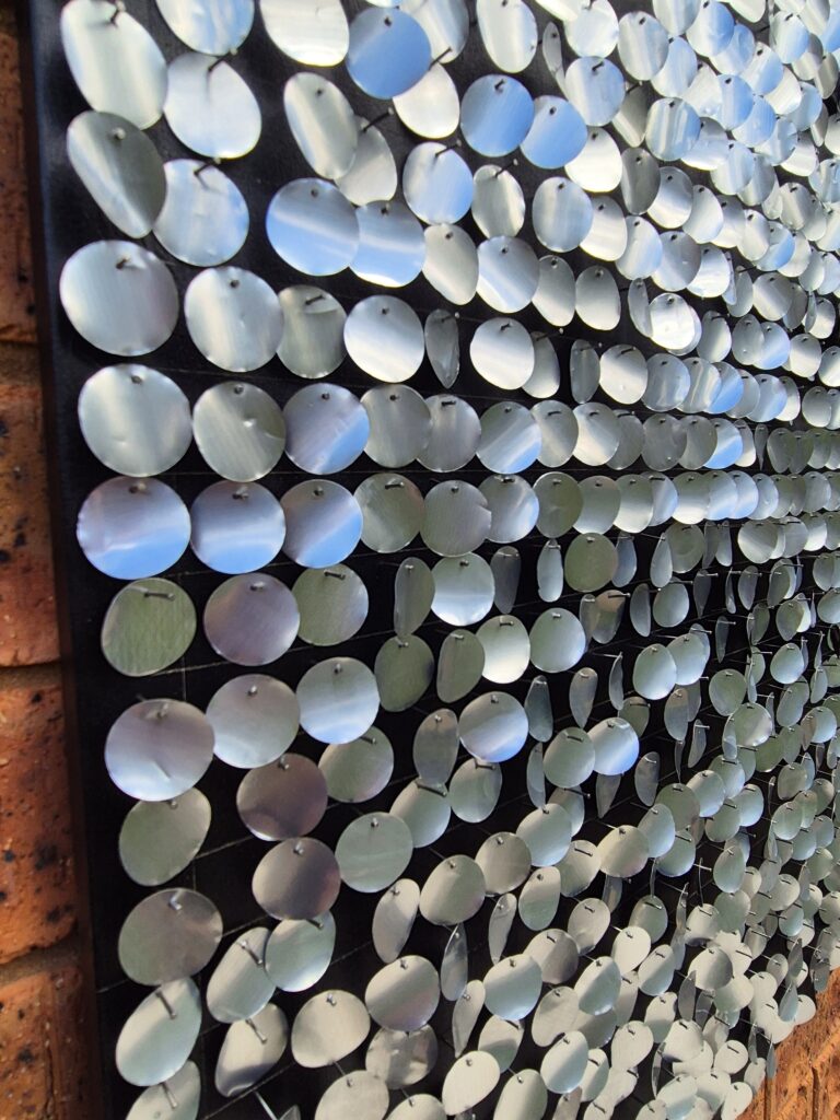 side view of aluminium circles nailed to the board