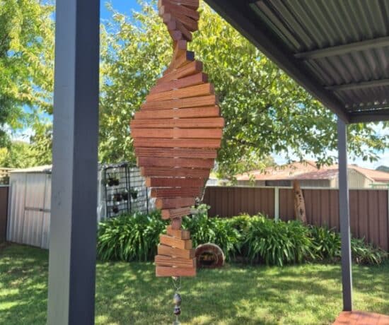 wooden wind spinner hanging in the wind