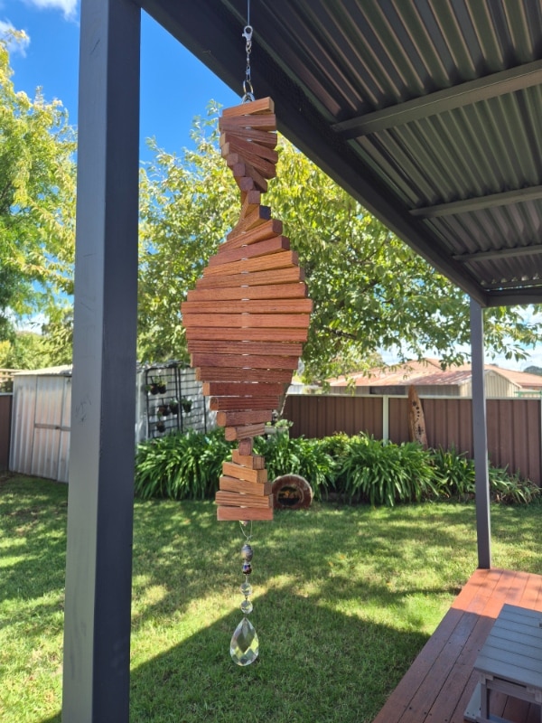 wooden wind spinner hanging in the wind