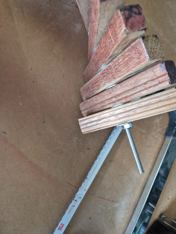 Cut away excess threaded rod with a hacksaw
