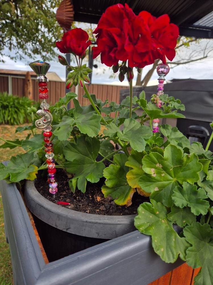 beaded garden stake inside planter to add colour
