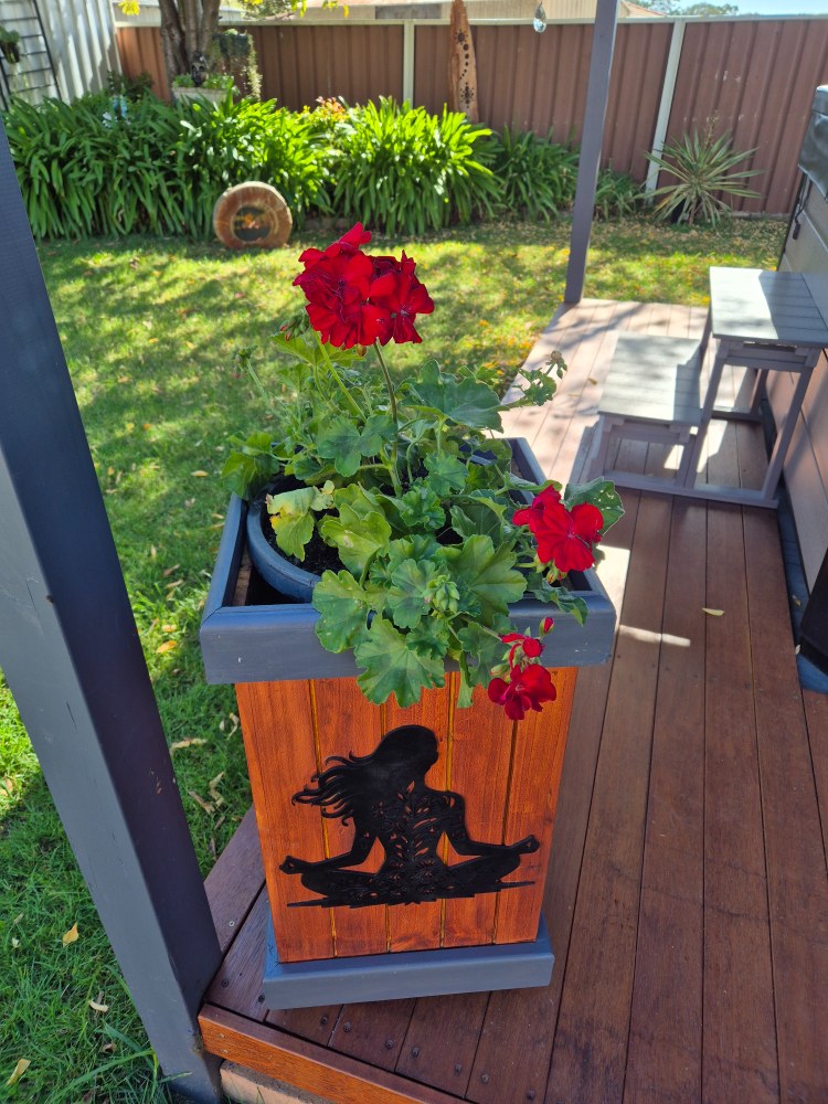 DIY wooden bin planter with legs on outdoor pergola deck