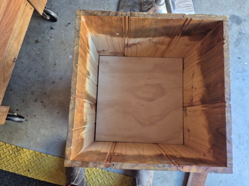 Add wood cut to size as a base for the plant pot